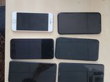 several cell phones are sitting on a table next to a cup of coffee