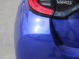 a close up of a blue car with the tail lights on
