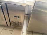 two stainless steel refrigerators in a kitchen next to each other