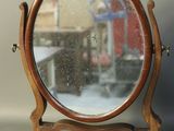a mirror that is on a stand on a table