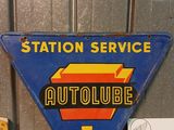a blue sign that says station service and a yellow sign that says autolube