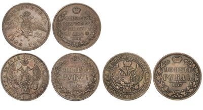 a group of five silver coins with the names of different countries