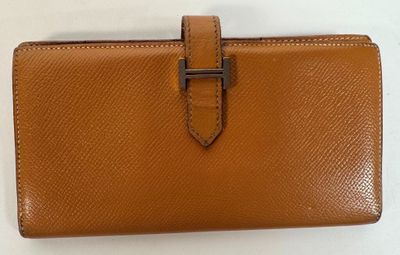 an image of a brown leather wallet with a metal clasp