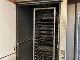 a metal door with a bunch of trays inside of it