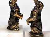 pair of bronze figurines of a man and a woman on marble bases