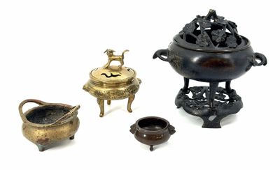 several different types of bronze objects are displayed on a white surface