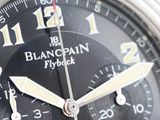 a close up of a watch with a black face