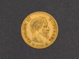 a close up of a gold coin with a man ' s head on it