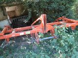a tractor plow that is sitting in the bushes