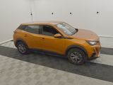 the orange car is parked in the garage on the checkered floor