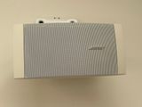 a white box with a speaker attached to it