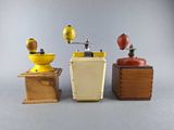 three different types of coffee grinders sitting on a table