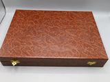 a wooden box with a lid that has a brown pattern on it