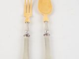 pair of silver plated forks and spoons on a white surface