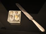 a knife and a box of condiments on a table