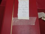 une feuille de papier posée sur la table, à laquelle est attachée une autre feuille de papier