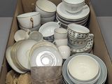 a box full of dishes and cups and saucers