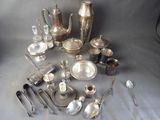 a lot of silverware on a table with spoons and spoons