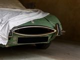 a car that is covered with a sheet in a garage