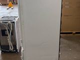 a white refrigerator in the middle of a room