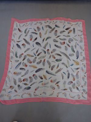 a picture of a pink and white scarf hanging on a wall