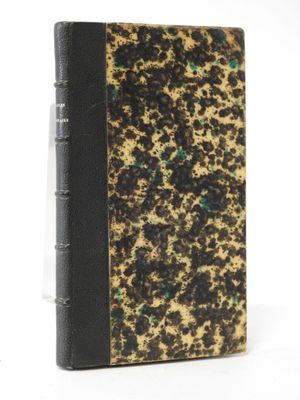 an old book with a black cover and gold speckles on it