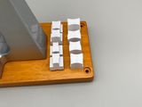 a wooden stand with a computer keyboard and a monitor on it