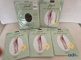 four pairs of women ' s tight stockings are sitting on a bed