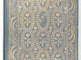 a blue and gold book with a bird on top of it