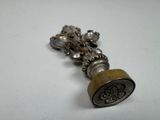 a metal bell with a bell hanging from it ' s end
