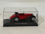 a red model of a car in a clear display case