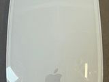 a white apple mouse sitting on top of a table