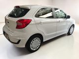 the rear end of a white car in a white room