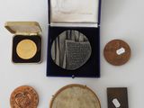 an image of a collection of coins and other items on a white surface
