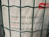 a large roll of white fabric wrapped around a wire fence
