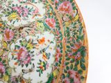 a plate with flowers and birds on it on a table