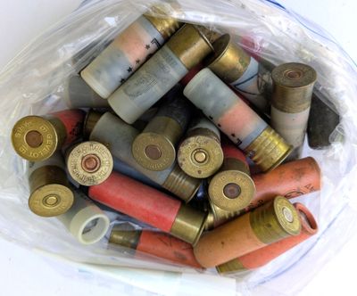un sac en plastique rempli de différentes sortes de cartouches de fusil de chasse