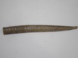 a long piece of metal on a white surface