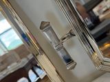 a mirror with a silver handle on it and a mirror with a silver handle on it