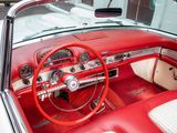 a red and white car with a steering wheel and dashboard