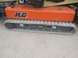 a picture of a small orange machine with a remote control