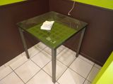 a glass table with a cell phone on top of it