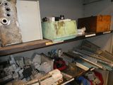 a shelf full of assorted items in a cluttered room