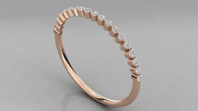a rose gold wedding band with a row of diamonds
