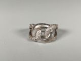 a close up of a silver ring on a white surface