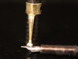 a close up of a fountain pen and a small metal object