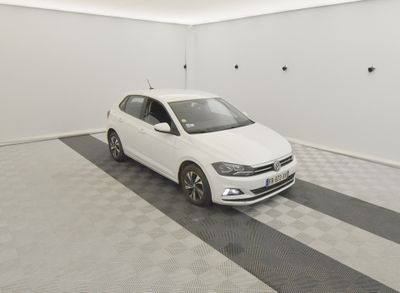 the white car is parked in the garage on the checkered floor