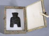 a small black object in a box on a table