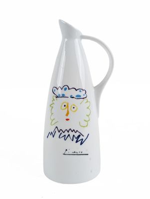 white ceramic jug with a drawing of a man ' s face on it