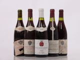 several bottles of wine are lined up on a table